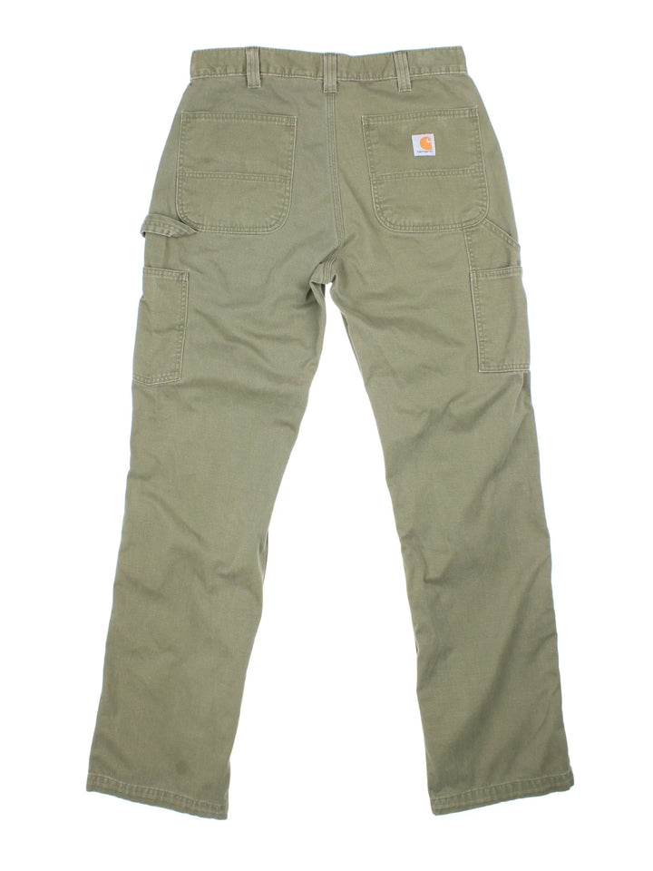 Carhartt Carpenter Trousers in a green colourway with multiple pockets and the logo embroidered on the back.