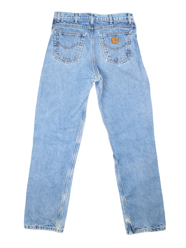 Carhartt Jeans in a blue colourway with multiple pockets, tartan lining, and the logo embroidered on the back.