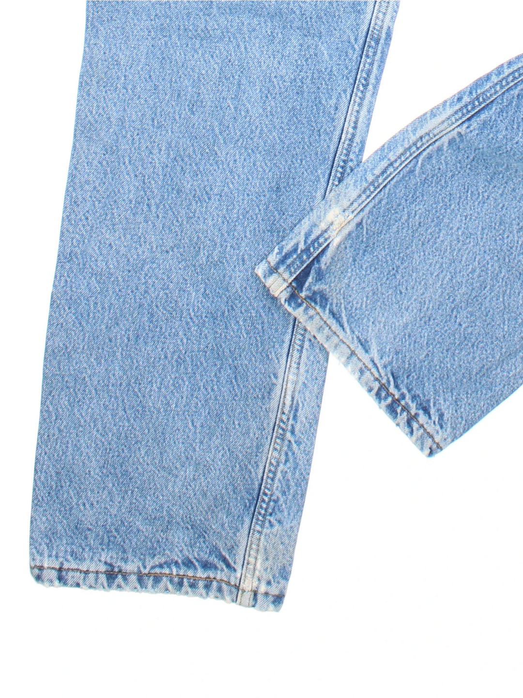 Carhartt Jeans in a blue colourway with multiple pockets, tartan lining, and the logo embroidered on the back.