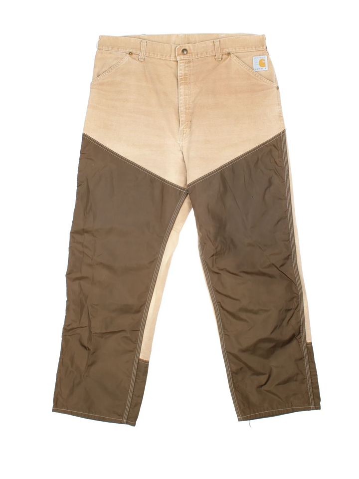 Carhartt Workwear Jeans in a tan and brown colourway with multiple pockets and the logo embroidered on the back.