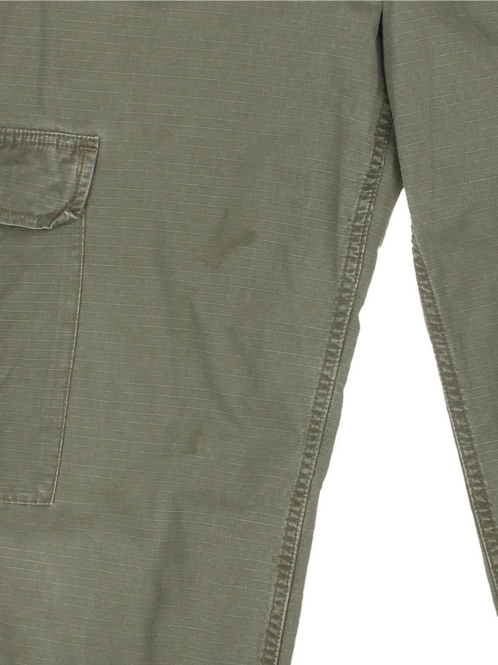 Carhartt Cargo Trousers in a green colourway with multiple pockets and the logo embroidered on the back.