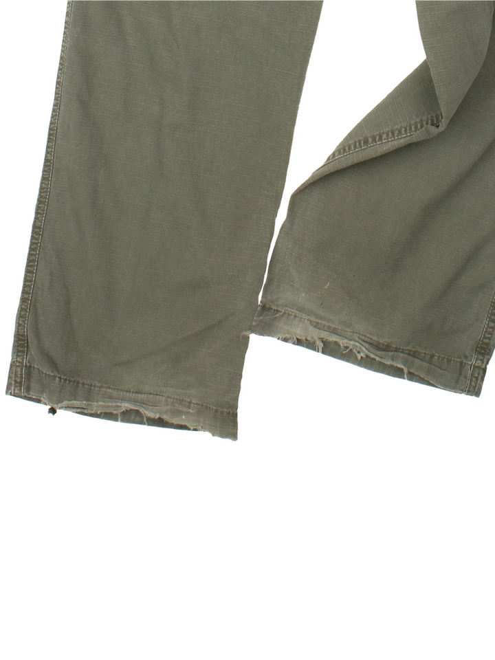Carhartt Cargo Trousers in a green colourway with multiple pockets and the logo embroidered on the back.