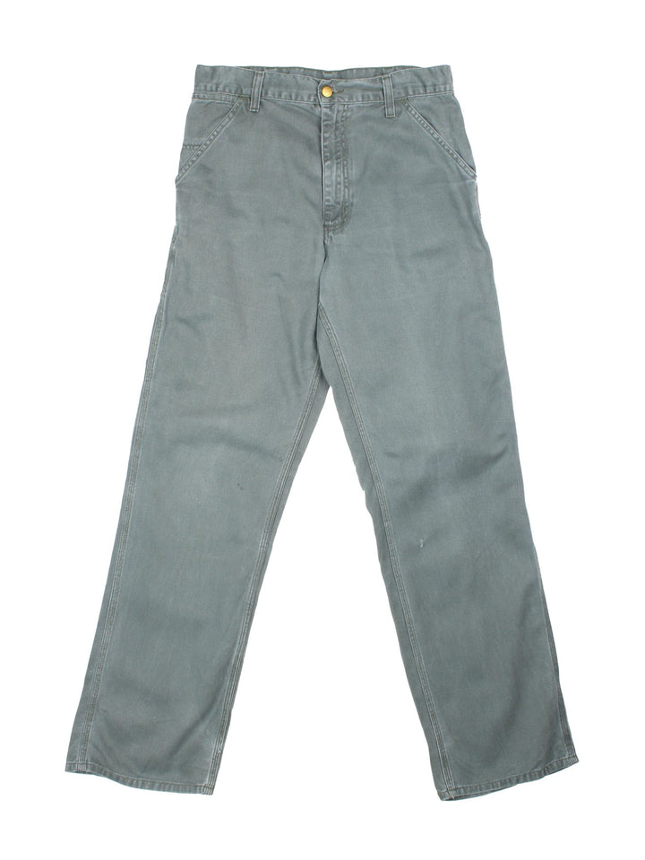 Carhartt Trousers in a faded blue colourway with multiple pockets and the logo embroidered on the back.