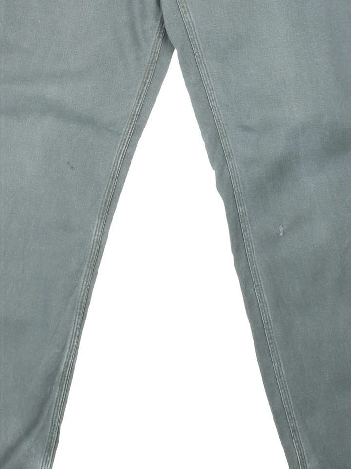 Carhartt Trousers in a faded blue colourway with multiple pockets and the logo embroidered on the back.