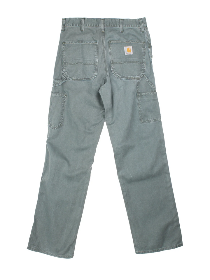 Carhartt Trousers in a faded blue colourway with multiple pockets and the logo embroidered on the back.