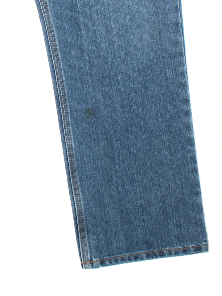 Carhartt Jeans in a blue colourway with multiple pockets, plaid pattern lining, and the logo embroidered on the back.