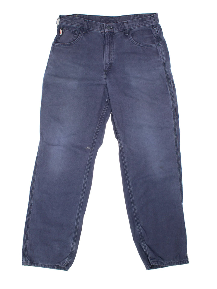 Carhartt Carpenter Trousers in a blue colourway with multiple pockets and the logo embroidered on the back.