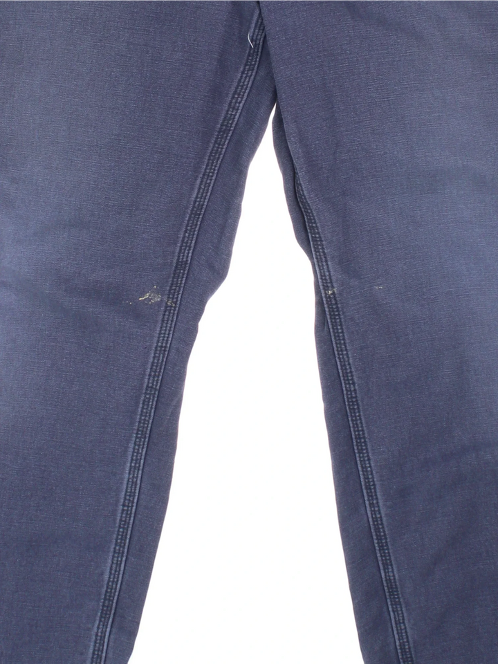 Carhartt Carpenter Trousers in a blue colourway with multiple pockets and the logo embroidered on the back.