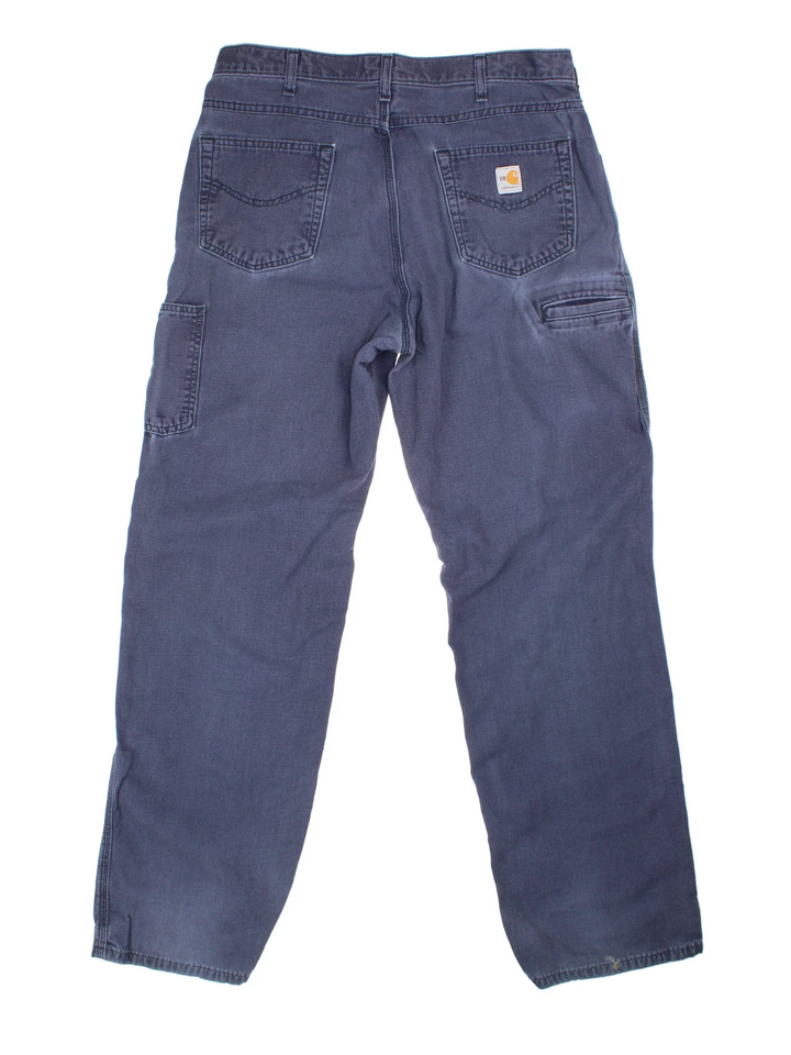 Carhartt Carpenter Trousers in a blue colourway with multiple pockets and the logo embroidered on the back.
