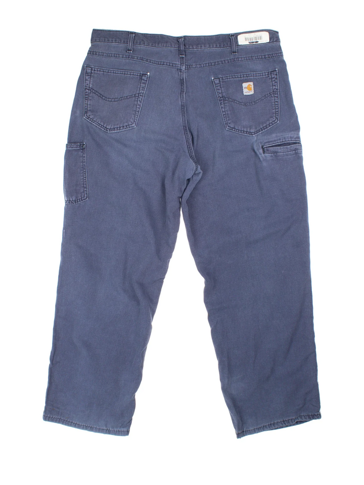 Carhartt Carpenter Trousers in a blue colourway with multiple pockets and the logo embroidered on the back.