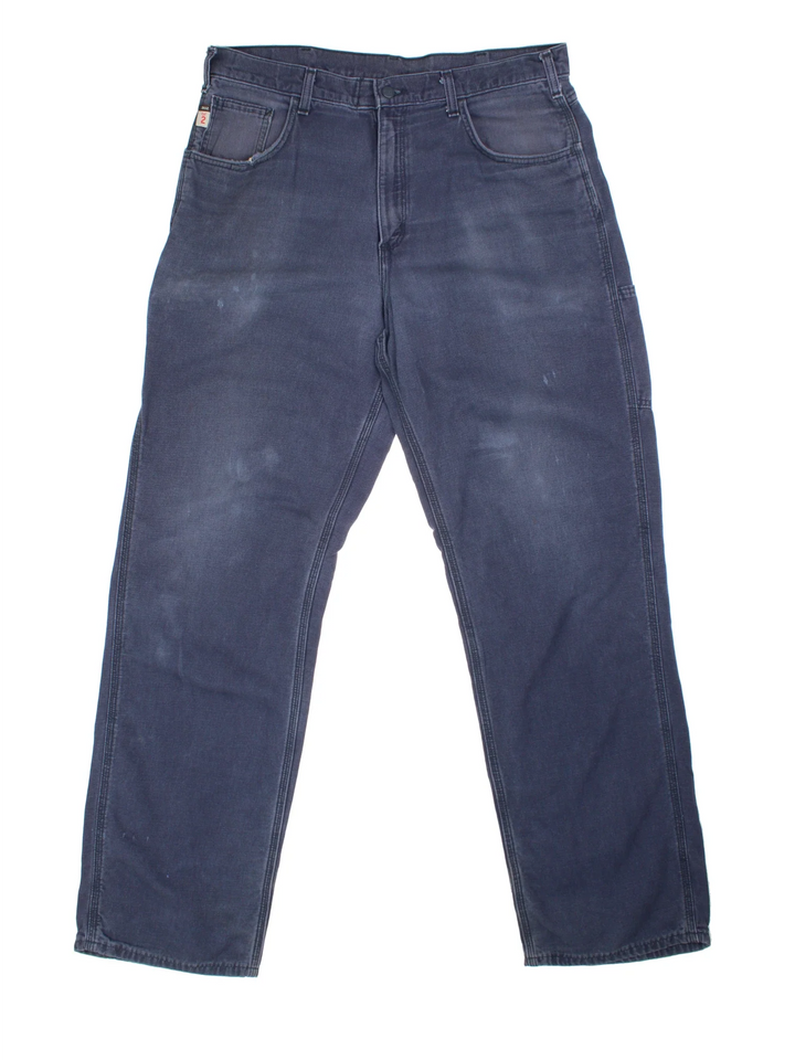 Carhartt Carpenter Trousers in a blue colourway with multiple pockets and the logo embroidered on the back.