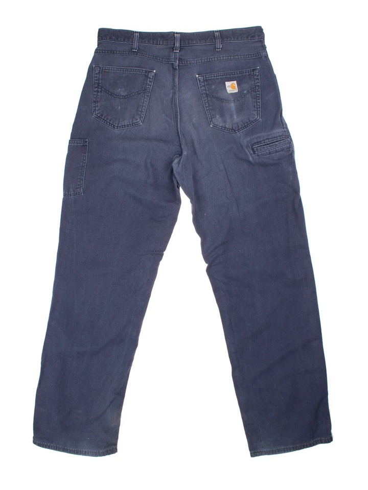 Carhartt Carpenter Trousers in a blue colourway with multiple pockets and the logo embroidered on the back.