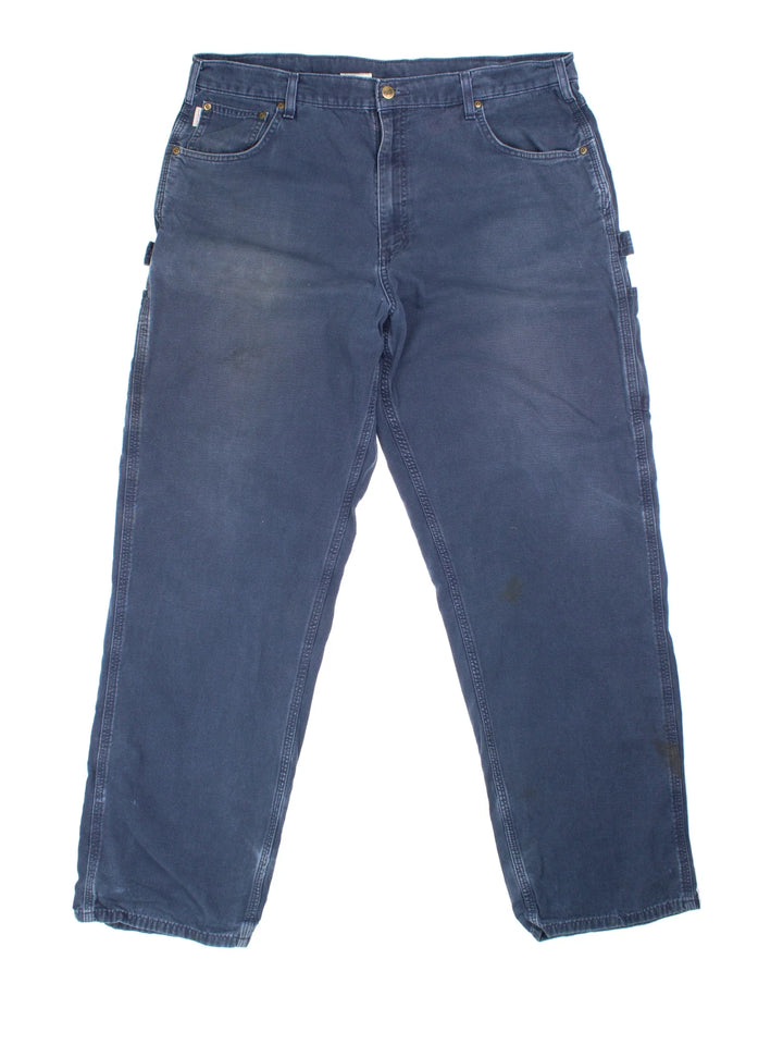 Carhartt Carpenter Trousers in a blue colourway with multiple pockets and the logo embroidered on the back.
