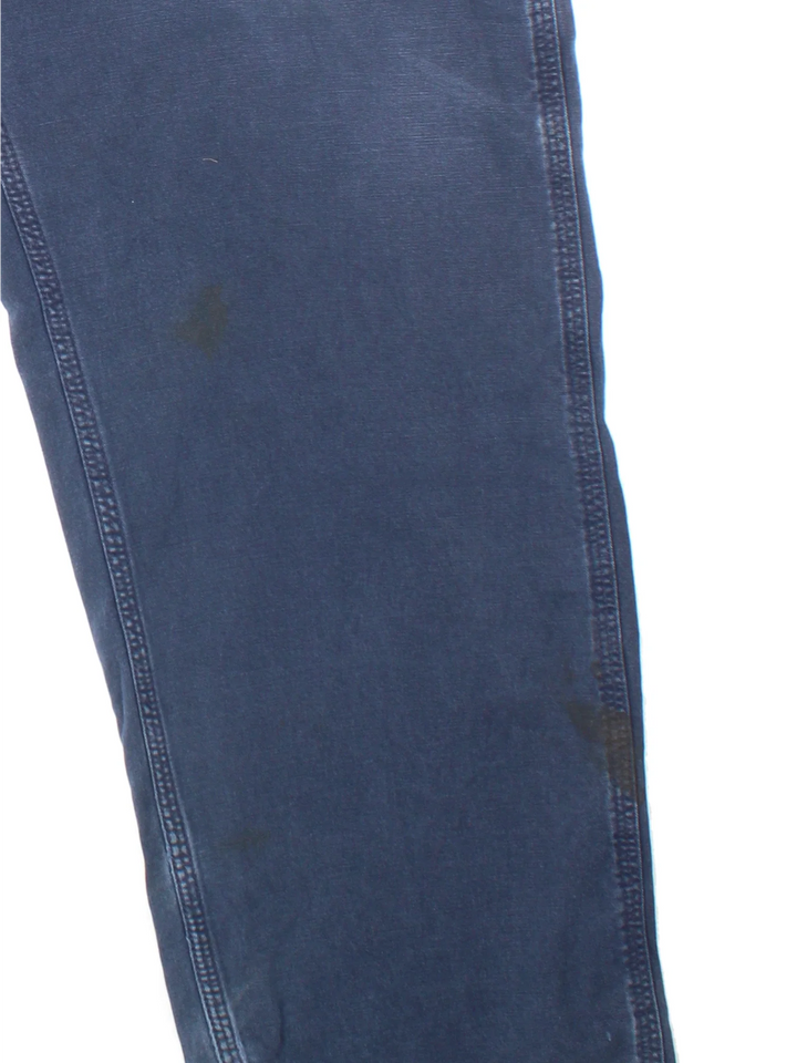 Carhartt Carpenter Trousers in a blue colourway with multiple pockets and the logo embroidered on the back.