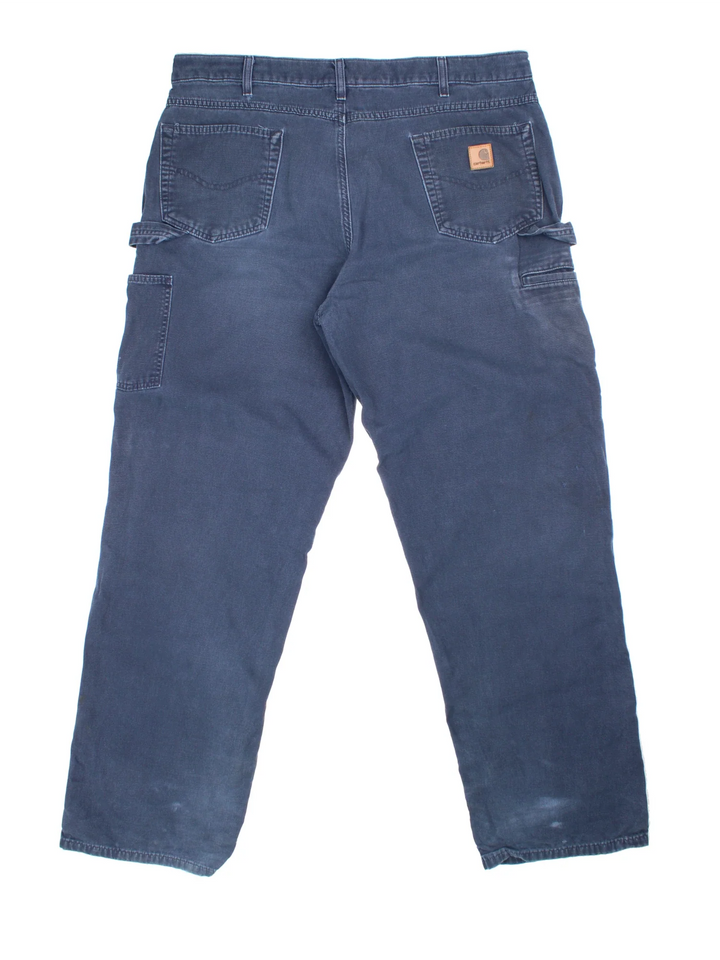 Carhartt Carpenter Trousers in a blue colourway with multiple pockets and the logo embroidered on the back.