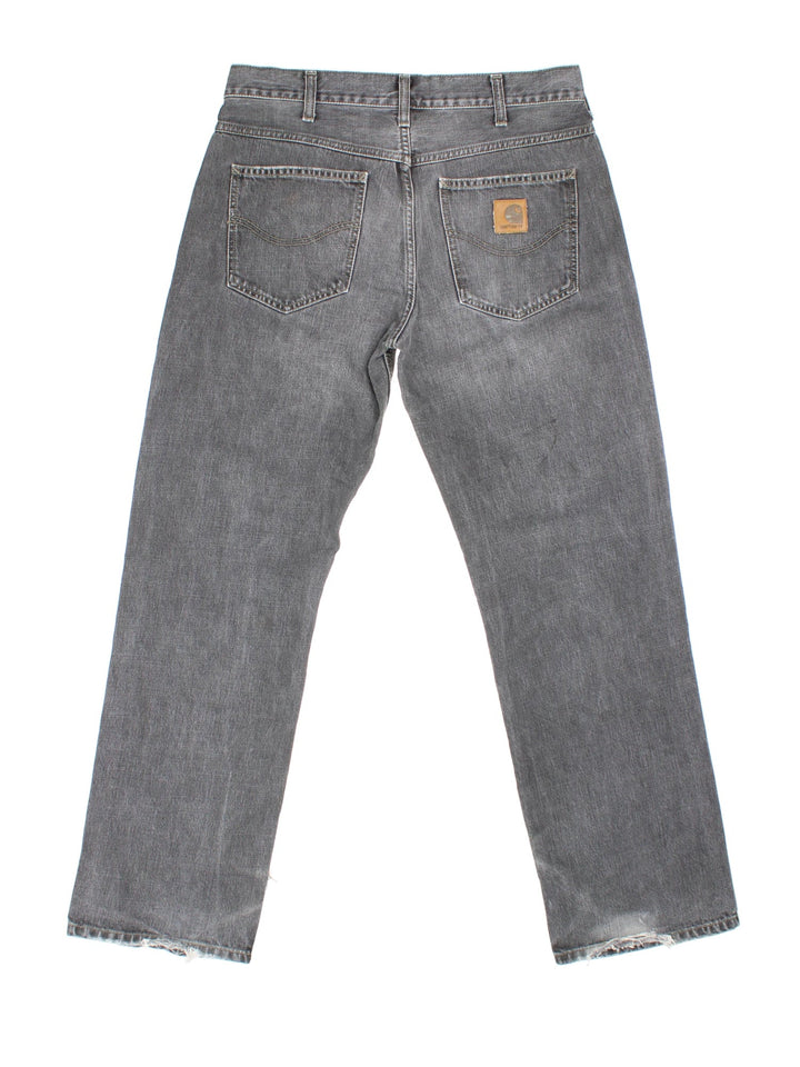 Carhartt Jeans in a grey colourway with multiple pockets and the logo embroidered on the back.