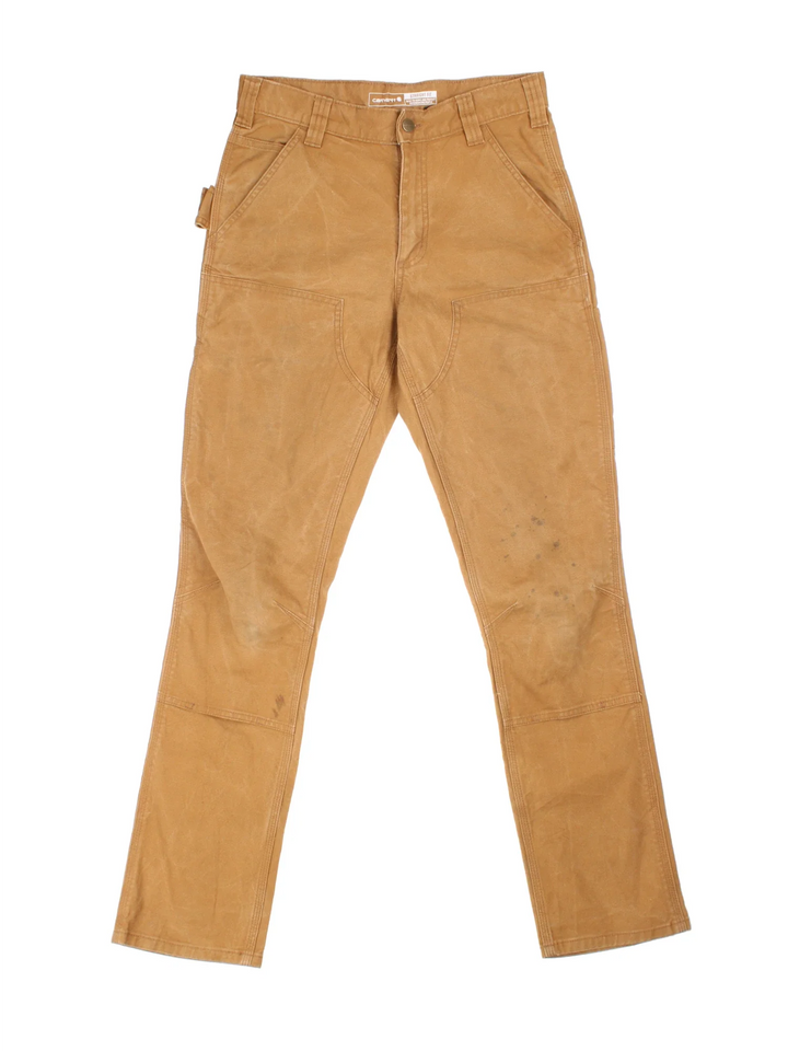 Carhartt Double Knee Jeans in a tan colourway with multiple pockets and the logo embroidered on the back.