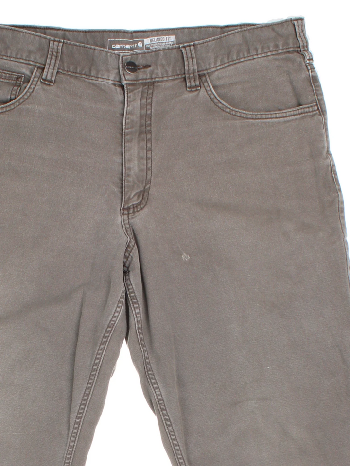 Carhartt Trousers in a grey colourway with multiple pockets and the logo embroidered on the back.