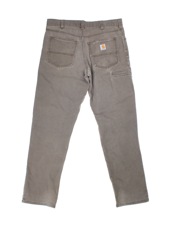 Carhartt Trousers in a grey colourway with multiple pockets and the logo embroidered on the back.