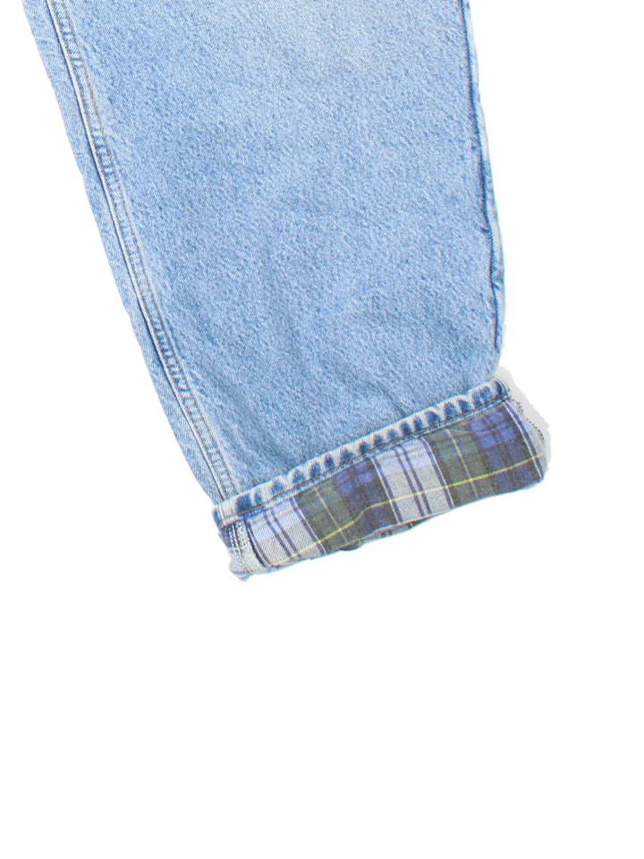 Carhartt Jeans in a blue colourway with brushed checked lining. Multiple pockets and the logo embroidered on the back.