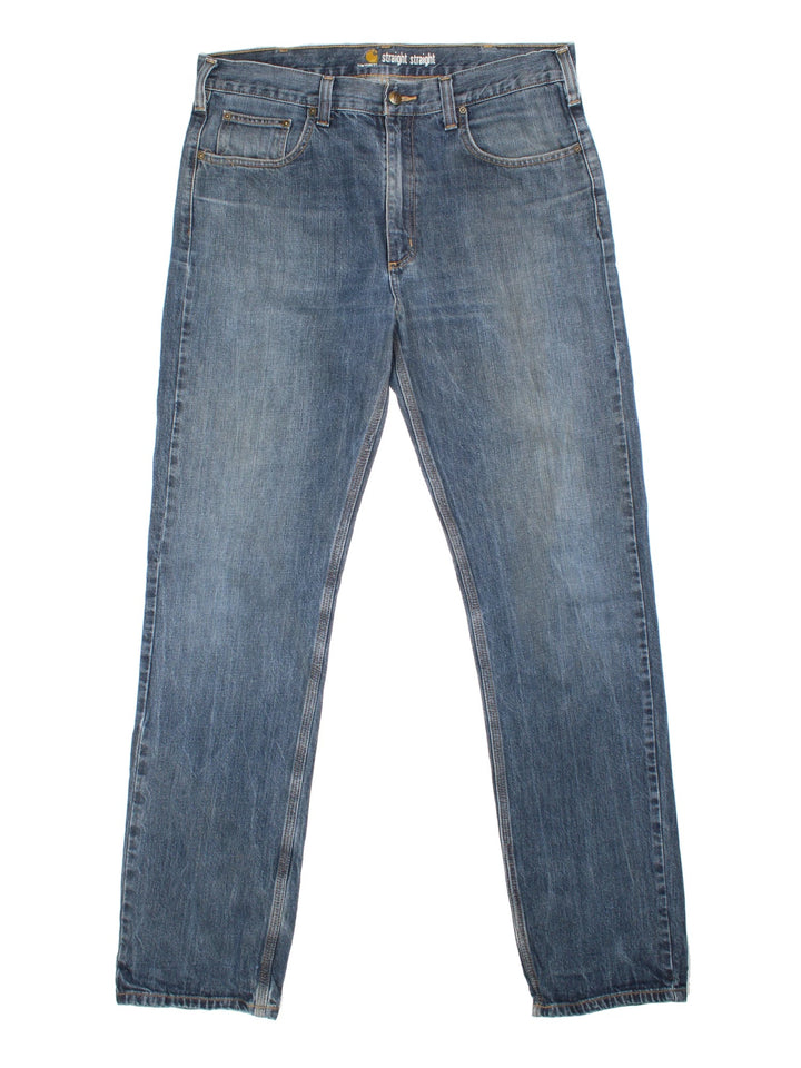 Carhartt Jeans in a blue colourway with multiple pockets and the logo embroidered on the back.
