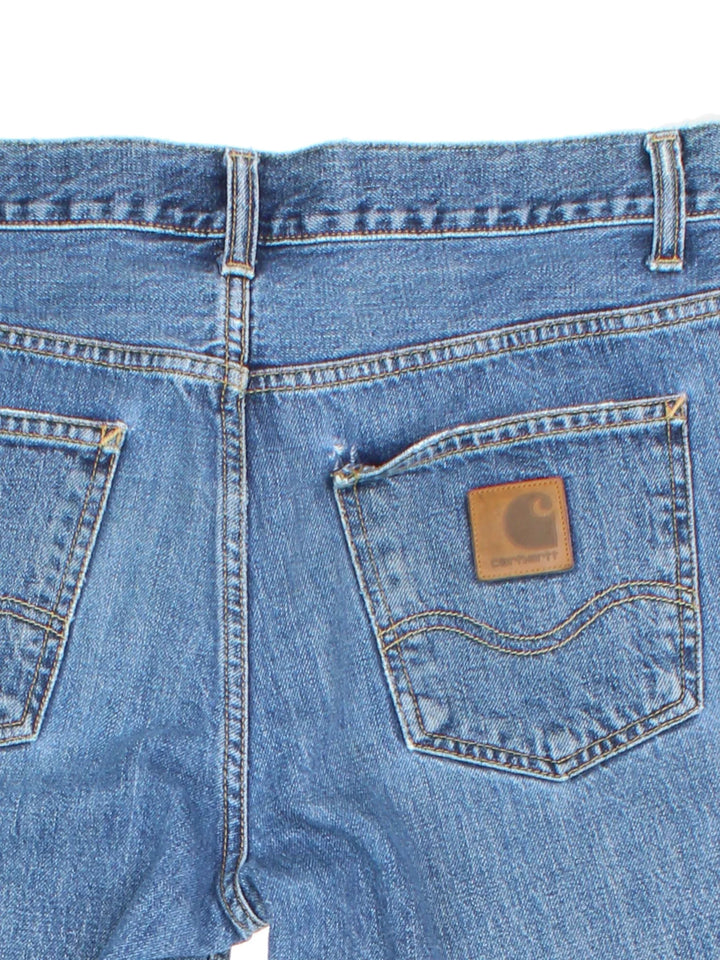 Carhartt Jeans in a blue colourway with multiple pockets and the logo embroidered on the back.