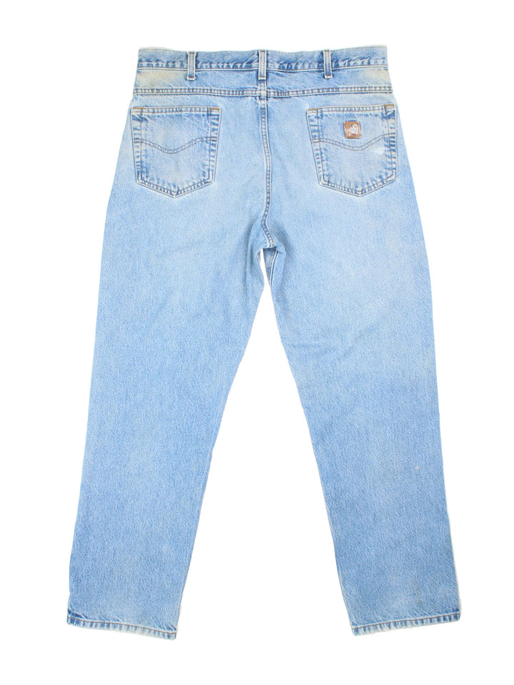 Carhartt Jeans in a blue colourway with multiple pockets and the logo embroidered on the back.