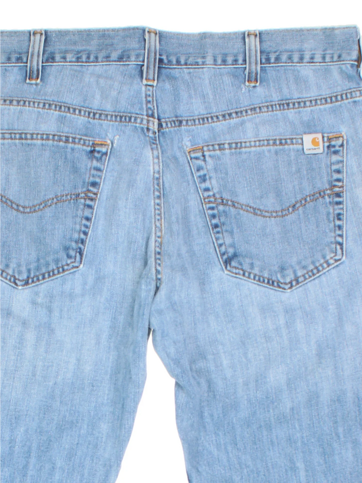 Carhartt Jeans in a blue colourway with multiple pockets and the logo embroidered on the back.