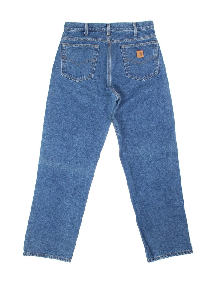 Carhartt Jeans in a blue colourway with brushed checked lining. Multiple pockets and the logo embroidered on the back.