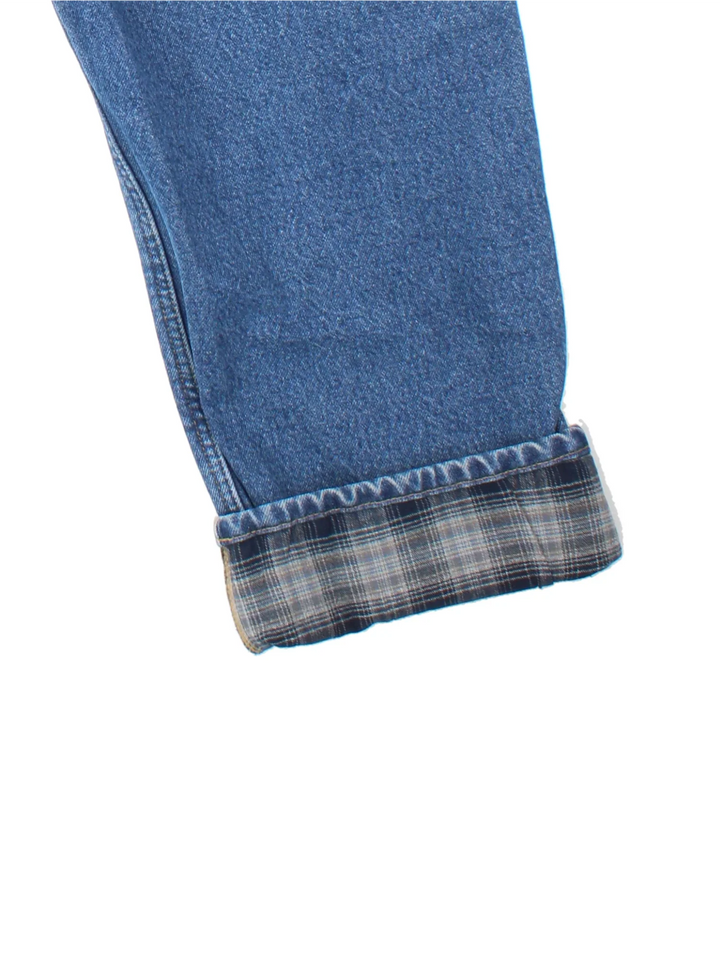 Carhartt Jeans in a blue colourway with brushed checked lining. Multiple pockets and the logo embroidered on the back.