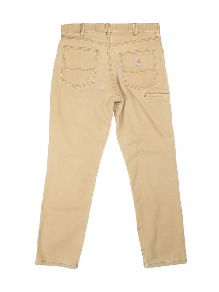 Carhartt Trousers in a tan colourway with multiple pockets and the logo embroidered on the back.