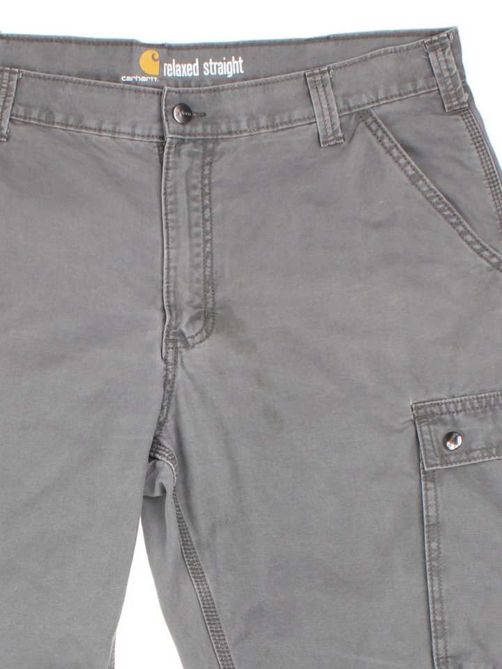 Carhartt Trousers in a grey colourway with multiple pockets and the logo embroidered on the back.