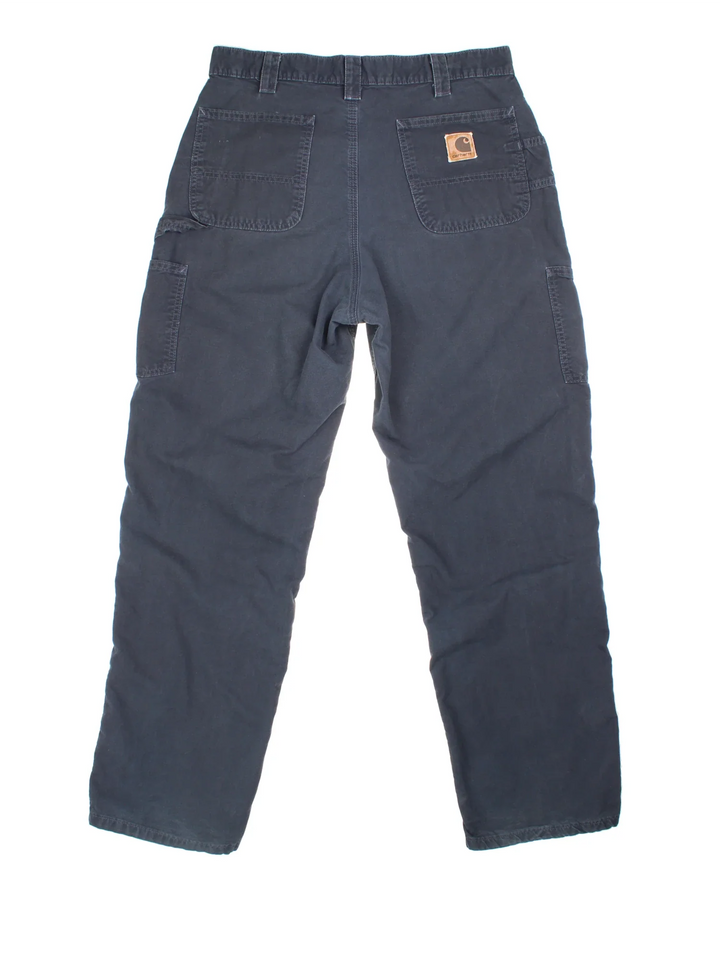 Carhartt Cargo Trousers in a blue colourway with multiple pockets and the logo embroidered on the back.