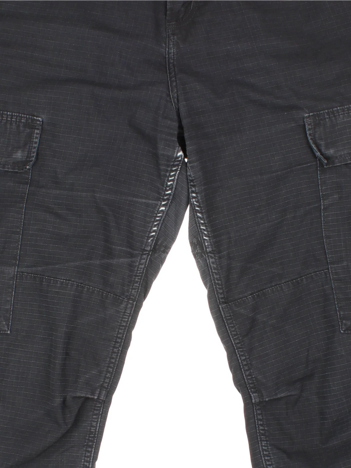 Carhartt Cargo Trousers in a black colourway with multiple pockets and the logo embroidered on the back.