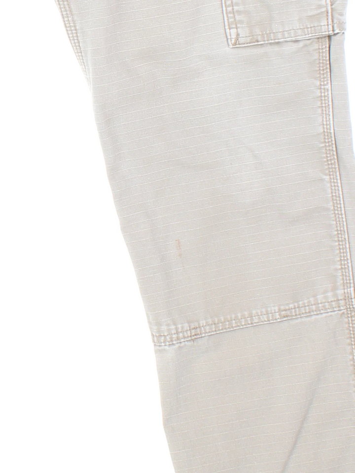 Carhartt Cargo Trousers in a tan colourway with multiple pockets and the logo embroidered on the back.