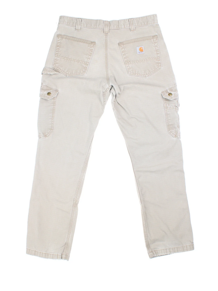 Carhartt Cargo Trousers in a tan colourway with multiple pockets and the logo embroidered on the back.