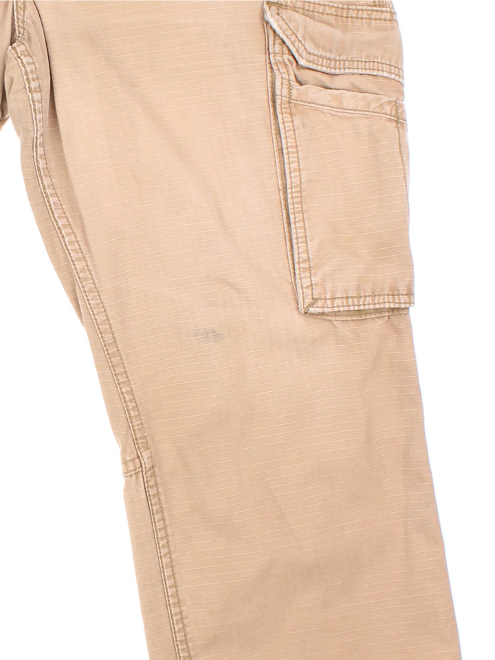 Carhartt Cargo Trousers in a tan colourway with multiple pockets and the logo embroidered on the back.