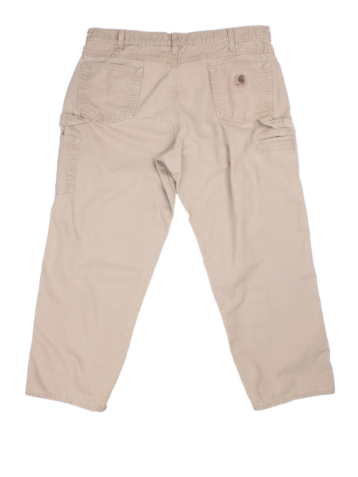 Carhartt Carpenter Jeans in a tan colourway with multiple pockets and the logo embroidered on the back.