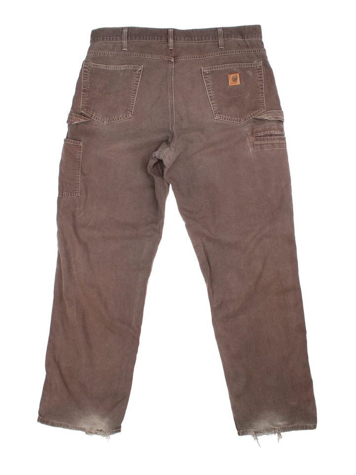 Carhartt Carpenter Jeans in a brown colourway with multiple pockets and the logo embroidered on the back.