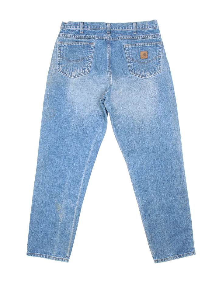 Carhartt Jeans in a blue colourway with multiple pockets and the logo embroidered on the back.