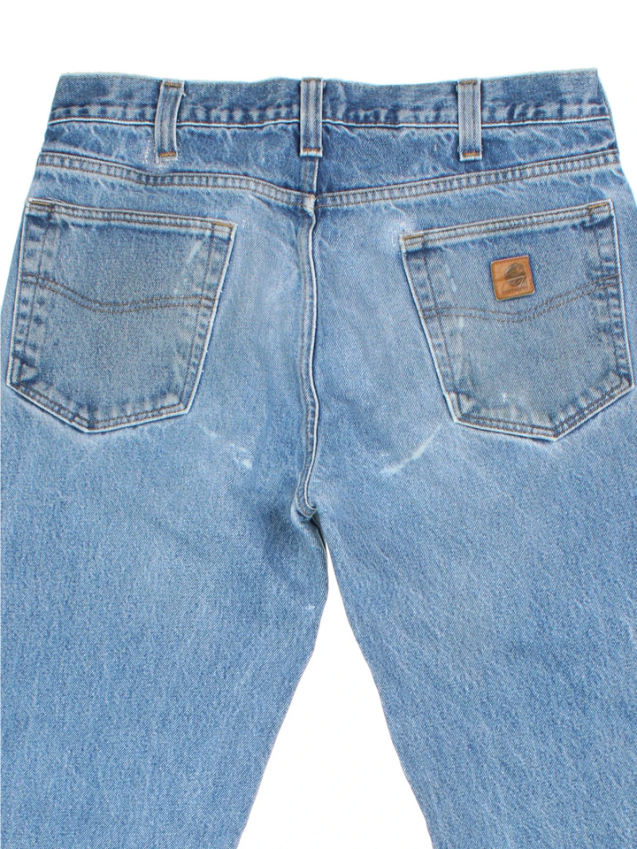 Carhartt Jeans in a blue colourway with multiple pockets and the logo embroidered on the back.