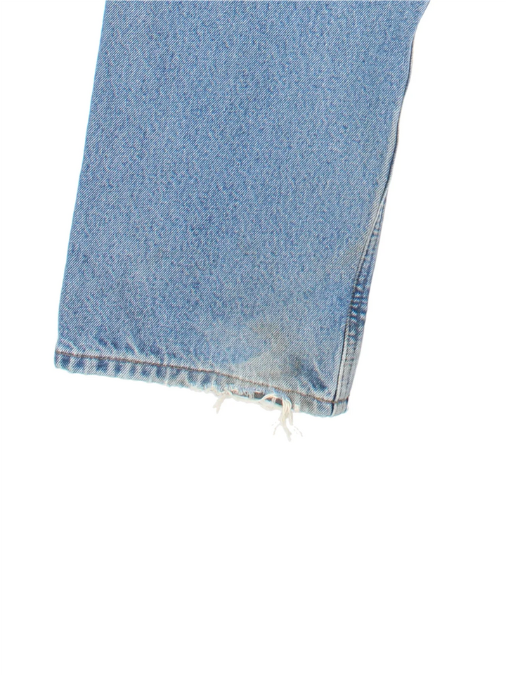 Carhartt Jeans in a blue colourway with multiple pockets, checked lining and the logo embroidered on the back.