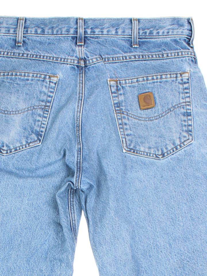 Carhartt Jeans in a blue colourway with multiple pockets and the logo embroidered on the back.