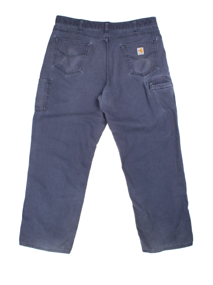 Carhartt Carpenter Trousers in a blue colourway with multiple pockets and the logo embroidered on the back.