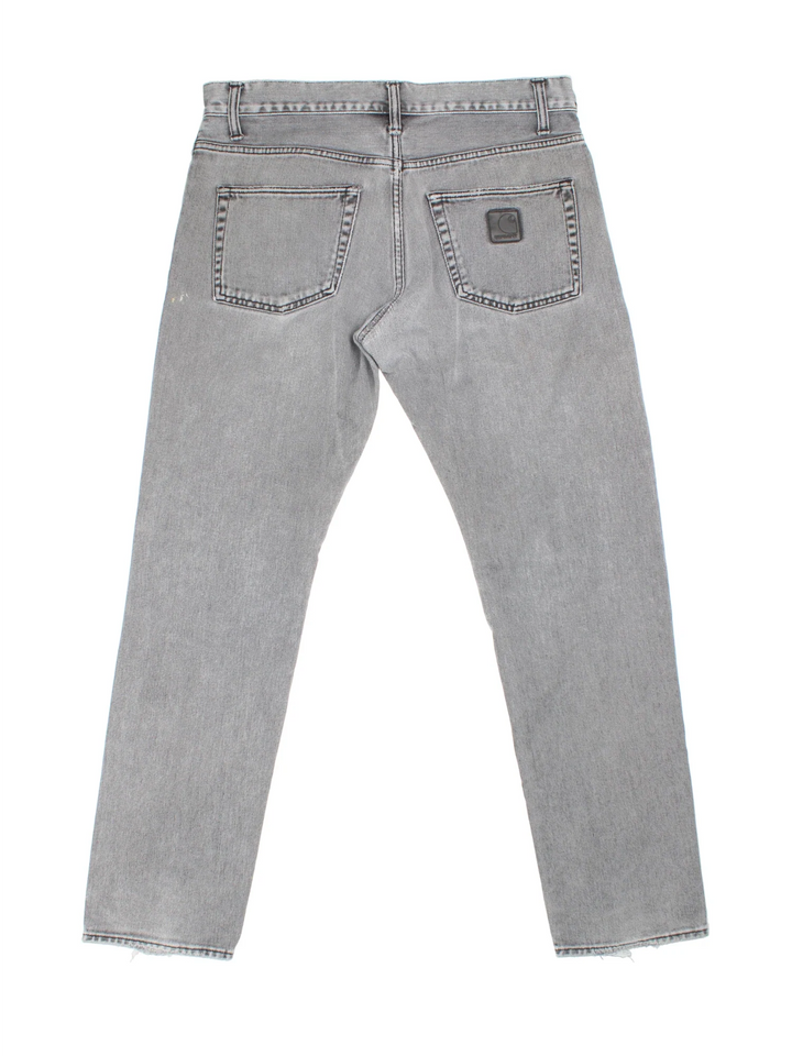 Carhartt Jeans in a grey colourway with multiple pockets and the logo embroidered on the back.