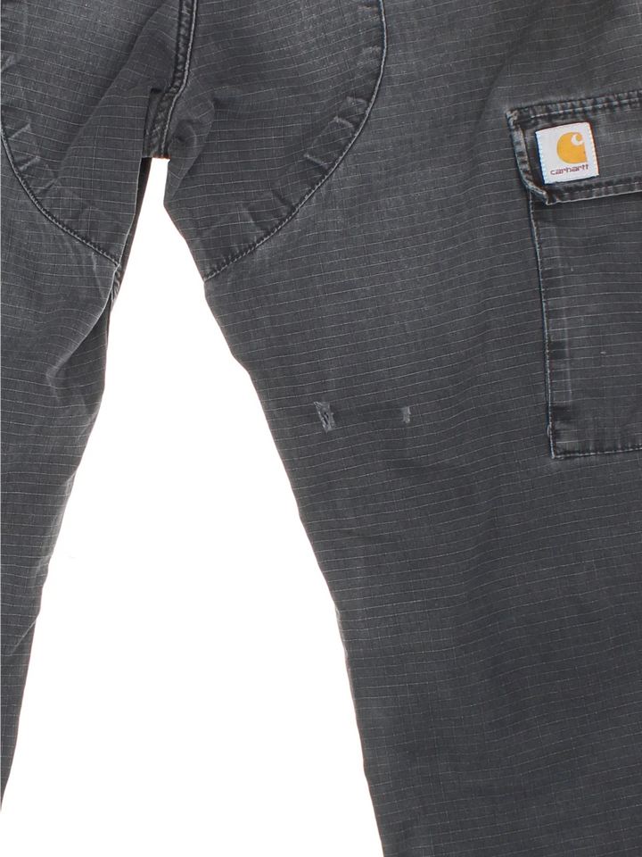 Carhartt Cargo Trousers in a black colourway with multiple pockets and the logo embroidered on the back.