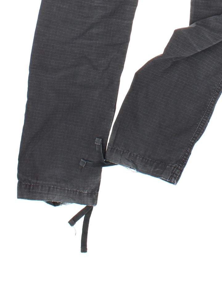 Carhartt Cargo Trousers in a black colourway with multiple pockets and the logo embroidered on the back.