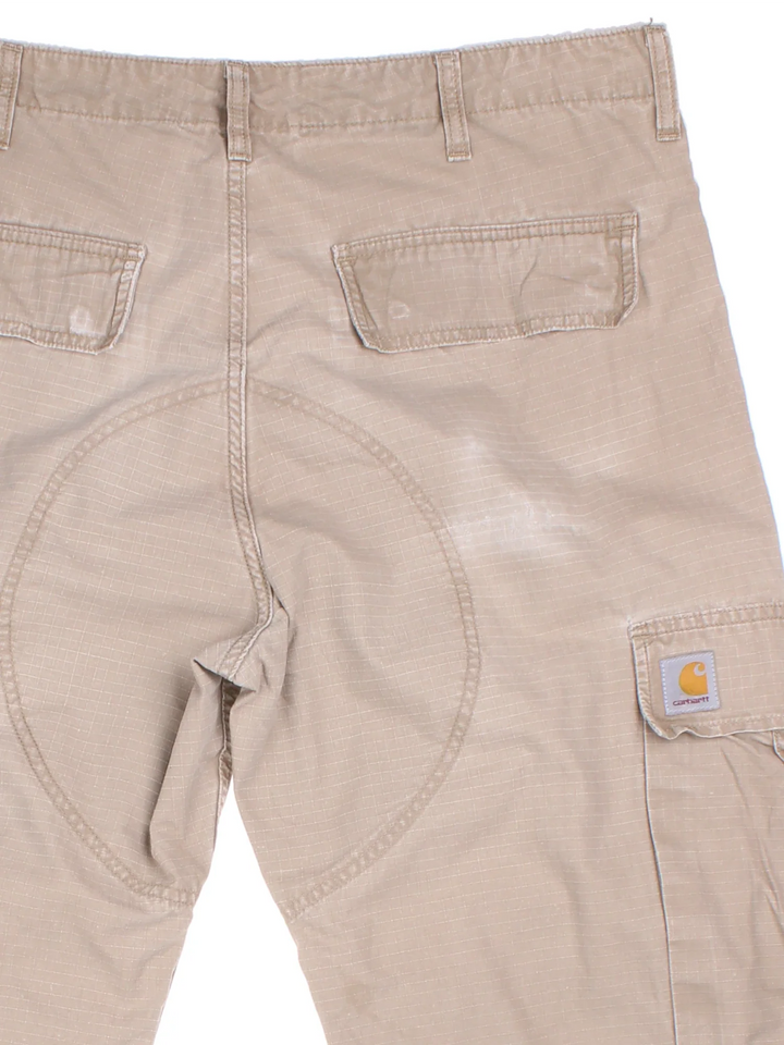 Carhartt Cargo Trousers in a tan colourway with multiple pockets and the logo embroidered on the back.