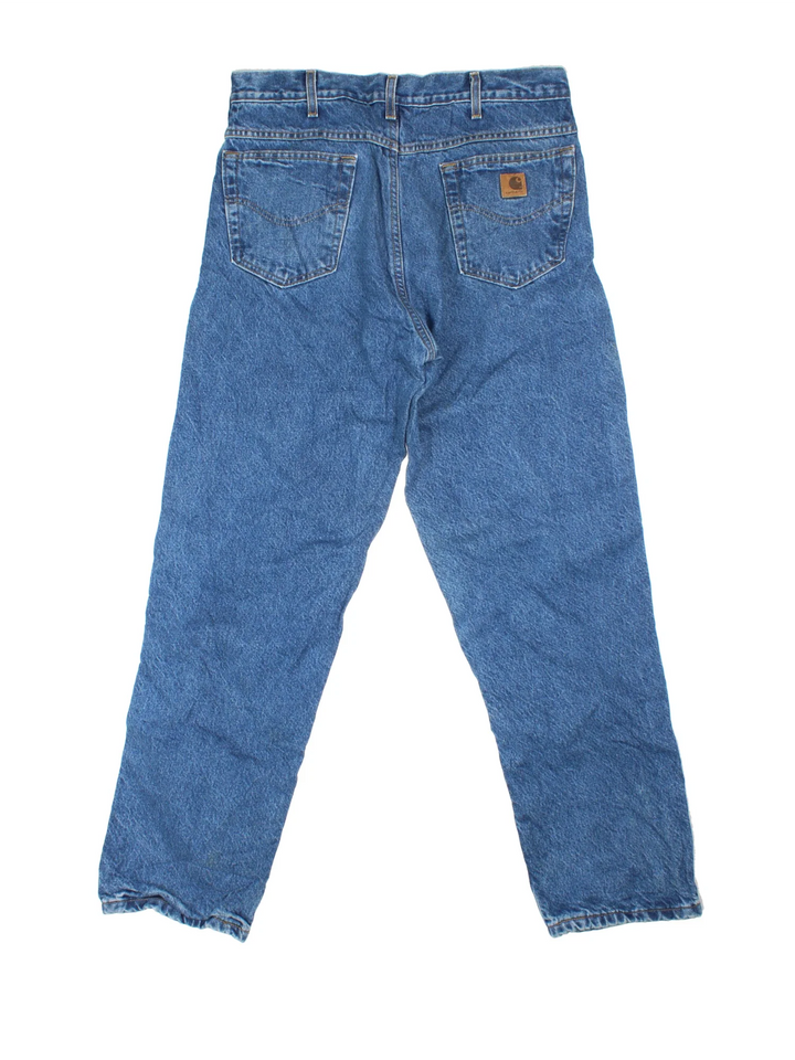 Carhartt Jeans in a blue colourway with multiple pockets, plaid pattern lining and the logo embroidered on the back.
