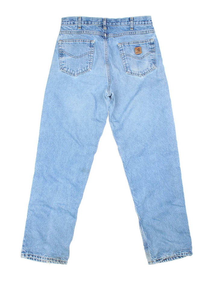 Carhartt Jeans in a blue colourway with multiple pockets, plaid pattern lining and the logo embroidered on the back.
